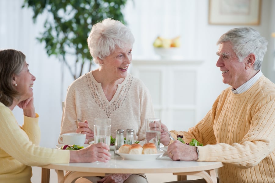 Seniors eating and laughing